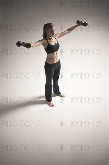 Caucasian woman exercising with dumbbells