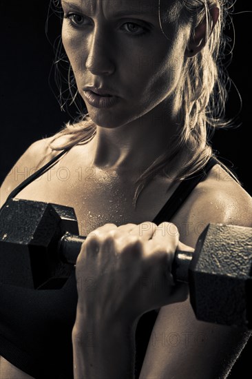 Caucasian woman exercising with dumbbells