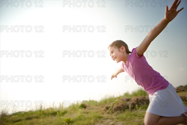 Mixed race girl running outdoors