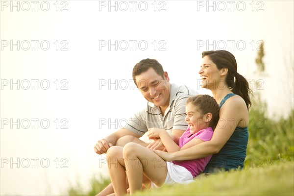 Family sitting in grass together