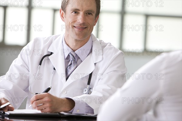 Caucasian doctor talking to patient