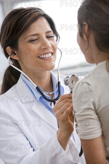 Smiling Doctor examining patient