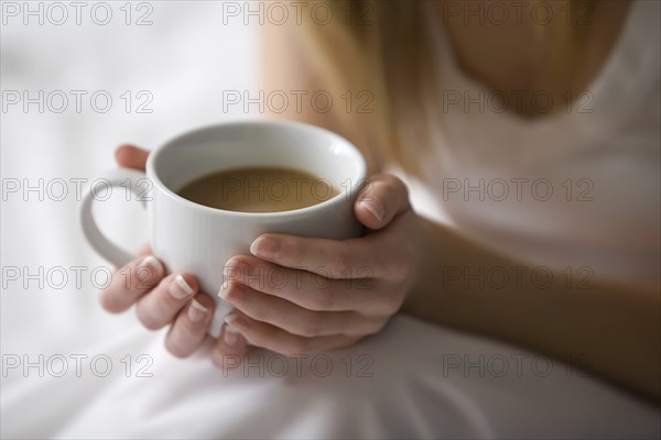 Caucasian woman holding cup of coffee