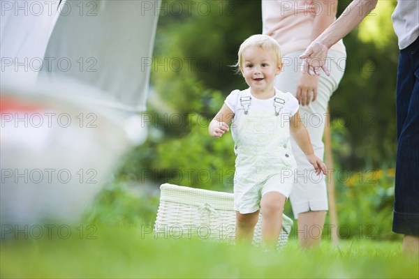 Caucasian baby running in grass