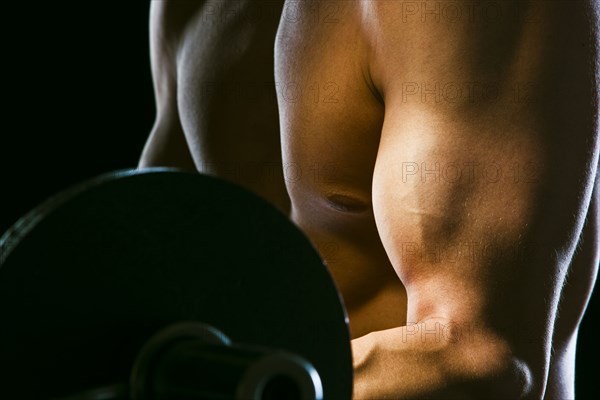 Caucasian man exercising with barbells