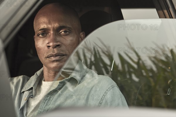 Serious African American man in car