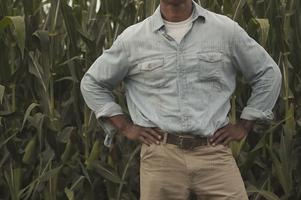 African American farmer standing with hands on hips