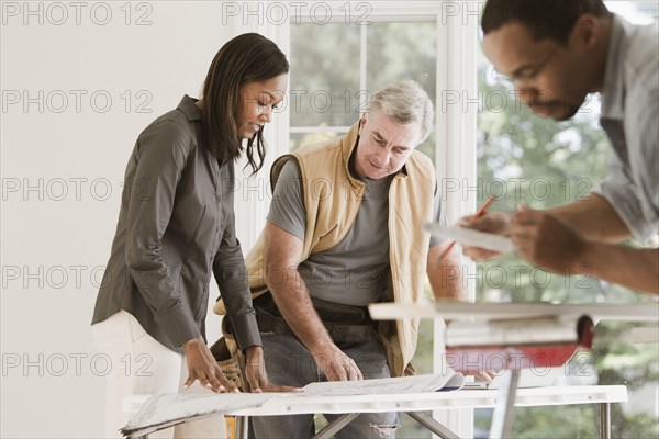 Man and woman looking at blueprints together