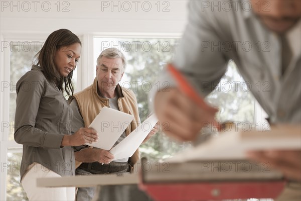 Man and woman looking at blueprints together