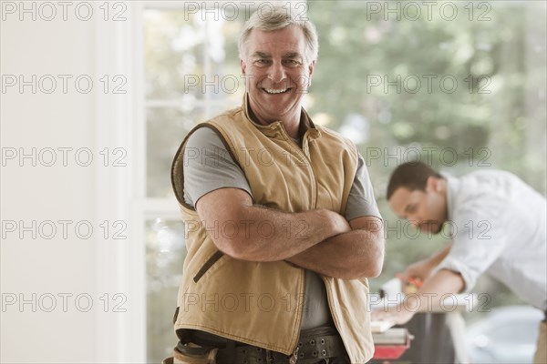 Caucasian carpenter standing with arms crossed