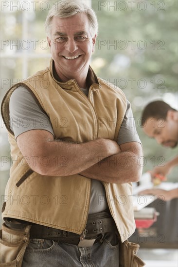 Caucasian carpenter standing with arms crossed