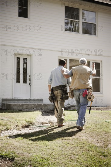 Carpenters walking toward house