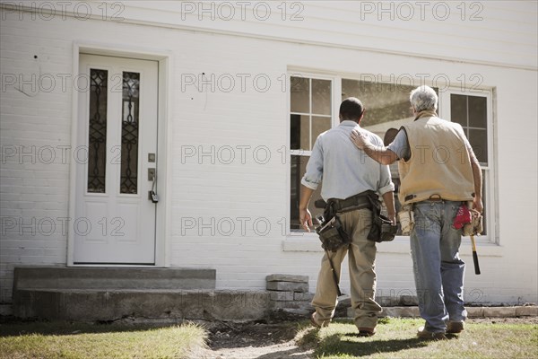 Carpenters walking toward house