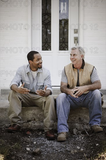 Carpenters sitting on front stoop