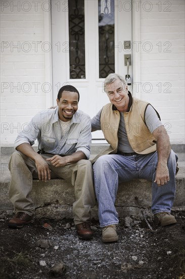 Carpenters sitting on front stoop