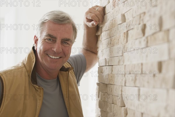 Caucasian man leaning against wall