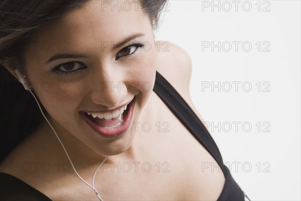 Mixed race woman listening to headphones and singing