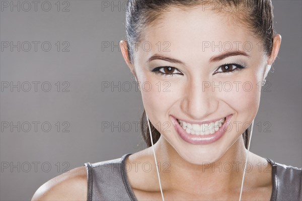 Smiling mixed race woman listening to headphones