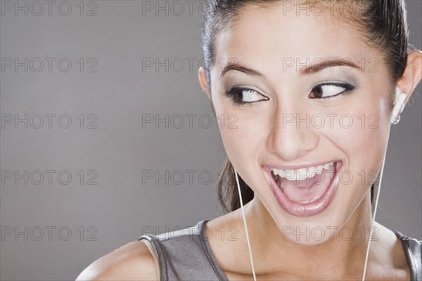 Smiling mixed race woman listening to headphones