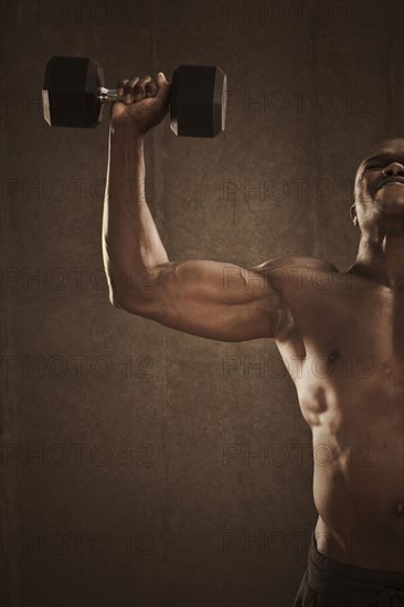 African American man lifting weights