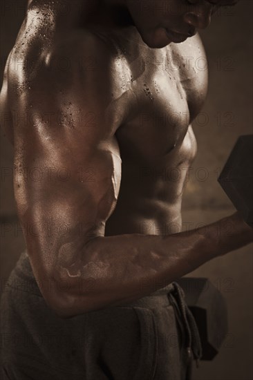 African American man lifting weights