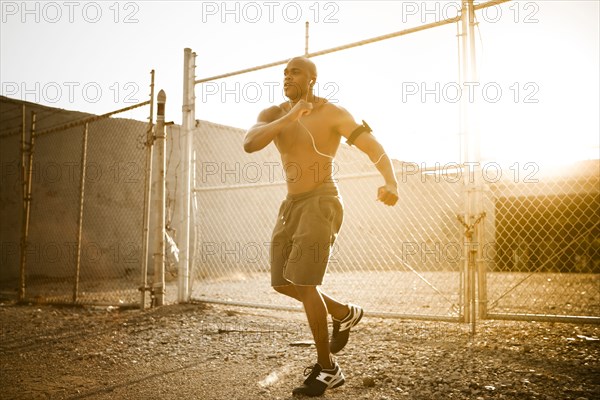 African American man exercising with mp3 player