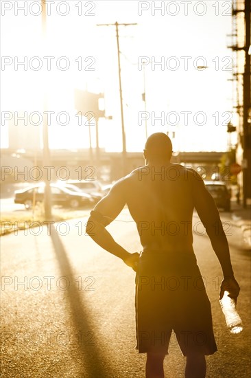 African American man drinking water after exercise