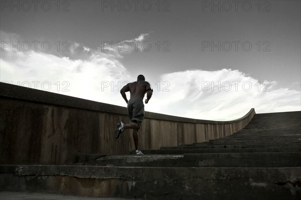 Black man running up stairs