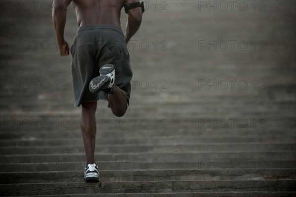 Black man running up stairs