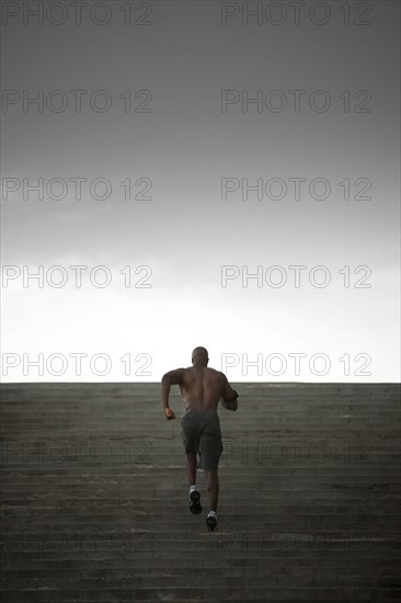 Black man running up stairs