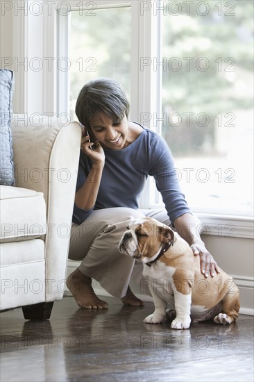 Native American woman petting English bulldog