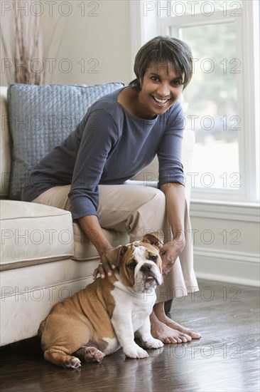 Native American woman petting English bulldog