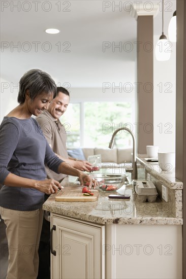 Couple preparing meal together in kitchen