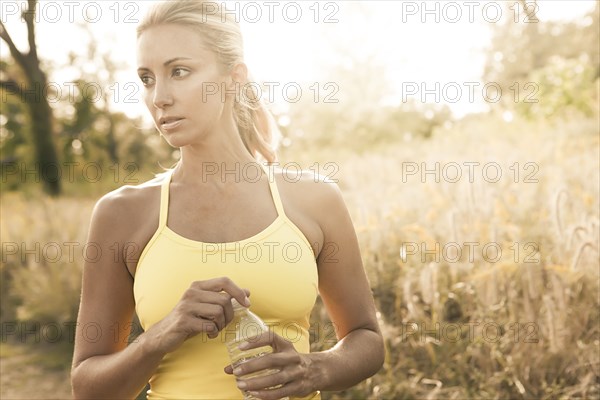 Caucasian woman holding water bottle outdoors