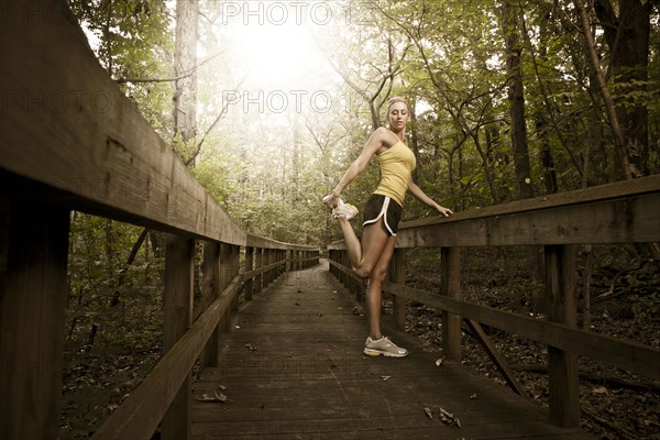 Caucasian woman stretching before exercise