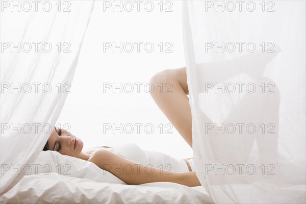 Caucasian woman laying in bed