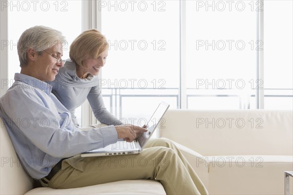 Caucasian couple using laptop together