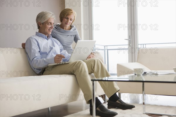 Caucasian couple using laptop together