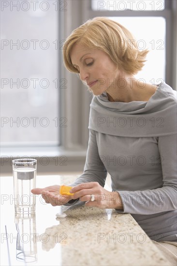 Caucasian woman taking medicine