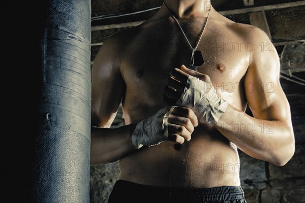 Midsection of Caucasian fighter with taped hands