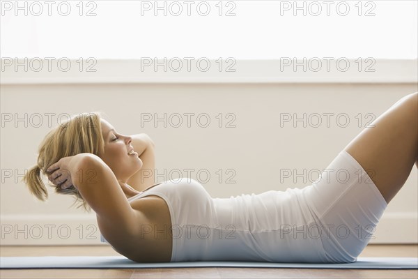 Caucasian woman doing sit-ups