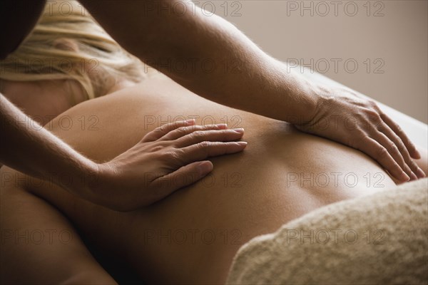 Caucasian woman receiving massage