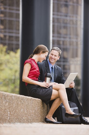 Caucasian co-workers talking outdoors