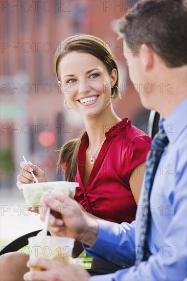Caucasian co-workers having lunch together outdoors