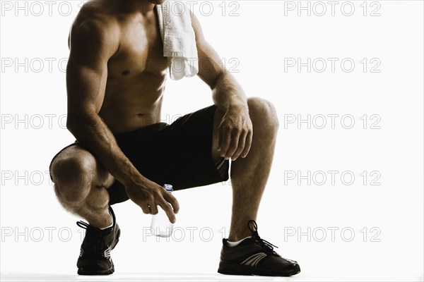 Caucasian man drinking water after exercise