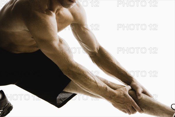 Caucasian man stretching before exercise