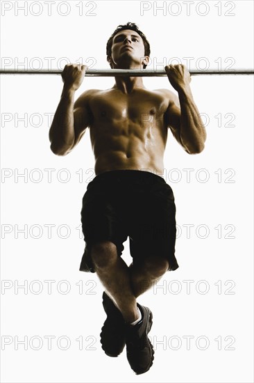 Caucasian man doing pull-ups