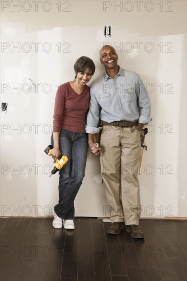 Couple holding hands in unfinished room