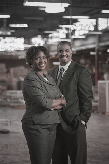 Black business people standing in warehouse