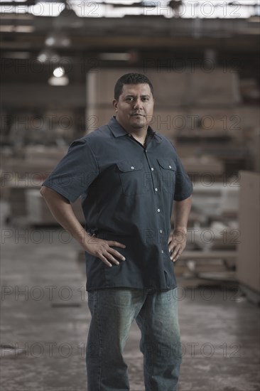 Hispanic worker standing in warehouse